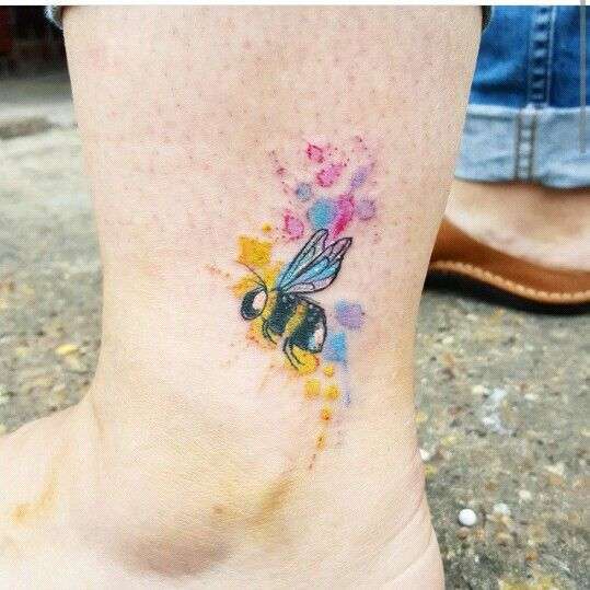 colourful watercolour bee tattoo