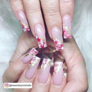 Long nude nails with marbled red, white and gold detailed french tips.