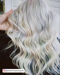 Long And Wavy White Blonde Hair With Subtle Pastel Colored Highlights