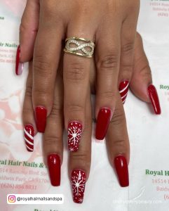 Christmas Red And White Coffin Nails With Stripes On A Book'S Surface
