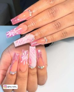 Long Light Pink Nails With Glitter And Snowflake Design