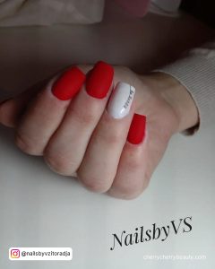Matte Red And White Nails With Cute &Quot;Be Happy&Quot; Inscription Laying On A White Surface