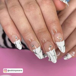Nude And White Oval French Tip Nails With Silver Chrome Tribal Design On The Tips