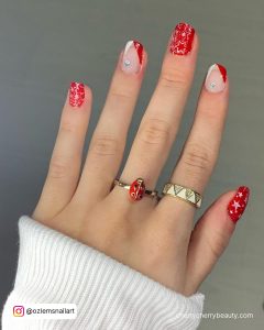 Red And White Christmas Nails With Rhinestones, French Tips, And Star Designs