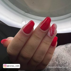 Simple Red And White Marble Nails In Front Of Ring Light