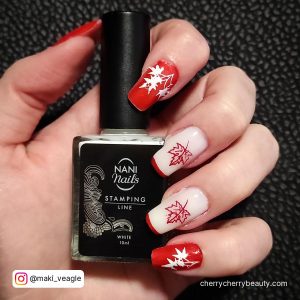 Spring Red And White Nails Short With Red Tips Holding A Bottle Of Nail Polish On A Black Surface