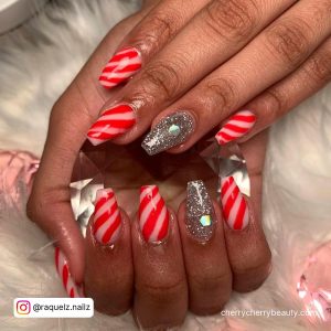 Striped Red White Acrylic Nails With Silver Glitter And Diamonds Over Fur