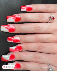 White And Red Ombre Nails With Red And White Ombré French Tips On Black Surface