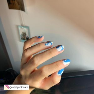 Adorable Squiggly Blue And White Nails Design Over White Surface