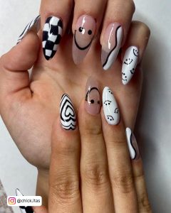 Almond Black And White Smiley Face Nails With Checkered Design And Love Art On A White Surface