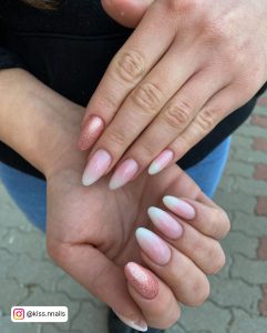 Almond Shape Milky White And Nude Ombre Nails With Rose Gold Glitter Feature Nail