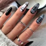 Black And White Checkered Nails With Plain Black Nails Over A Scented Candle And Pampas Grass