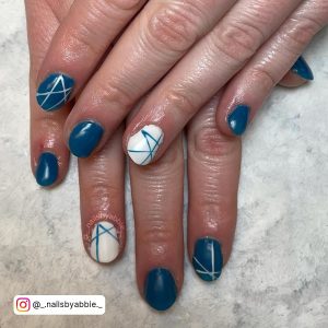 Blue And White Nail Design With Line Art Laying On White Surface