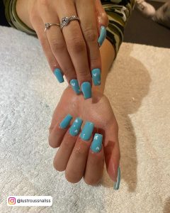 Blue Nails With White Hearts For A Summery Affect