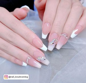 Bridal Ombre Pink To White Nails With Rhinestones On White Clothe