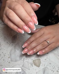 Chic Oval White Tip Nail Design Over Marble Surface