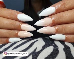 Chic White Ombre Stiletto Nails On Zebra Patterned Surface