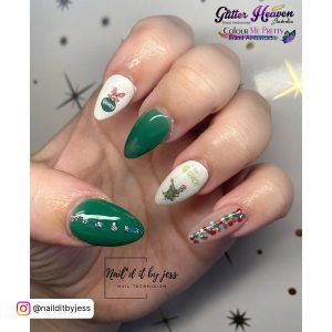 Christmas-Themed Green And White Acrylic Nails With The Grinch Design On Star Patterned Surface