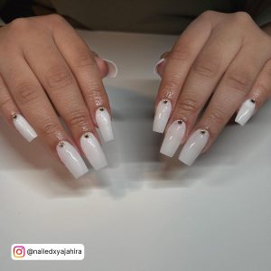 Classy Long White Acrylic Nails With Diamonds Over White Surface