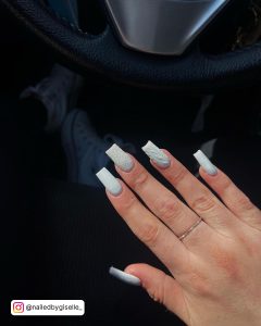 Classy White Glitter Nails Infront Of The Car Steering
