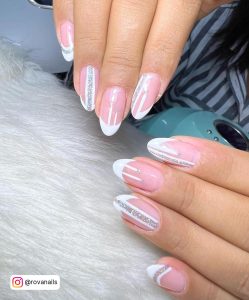 Classy White Tip Gel Nails With Glitter And Rhinestones Laying On White Fur