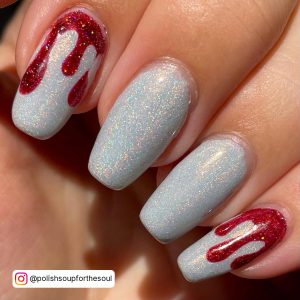 Close-Up Of White Glitter Nails That Has A Touch Of Red Color On The Index And Little Finger.