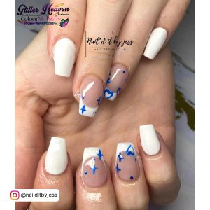 Cute Blue And White Acrylic Nails With Heart And Star Designs, And French Tips Over Marble Surface