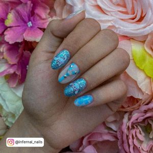 Cute Bunny Torquiose Blue And White Nails With Rhinestones And Glitters On Flowery Surface