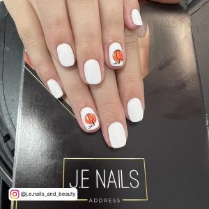 Cute Halloween White Gel Nails With Designs - Carttoon Pumpkin, Laying On Black Surface