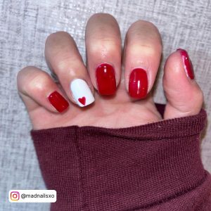 Cute Red And White Gel Nails With Heart On White Clothe