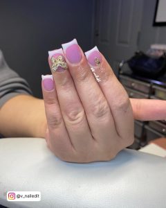 Cute Short Pink And White Acrylic Nails With Bling Butterfly And Rhinestones Over White Surface