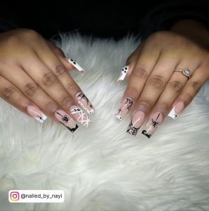 Cute Spooky Black And White Nail Art With White And Black French Tips, Line Work, And Mixed Designs On Fur Clothe
