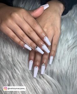 Cute White Nails With Diamonds On A Pillow