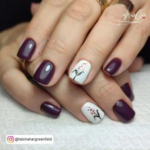 Cute Wine And White Gel Nails With Design Laying On White Surface