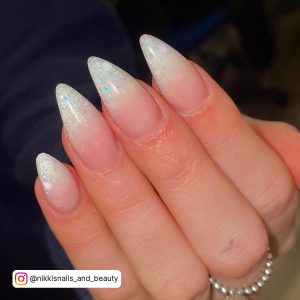 Dreamy Oval White Glitter Nails Infront Of Blue Sleeves