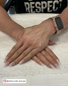 Easy Nude And White Ombre Nails With Rhinestones Over White Towel