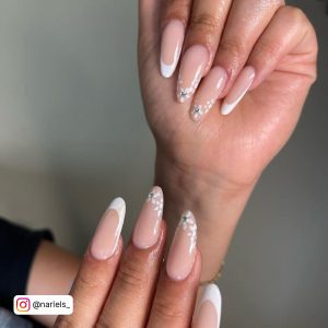 Elegant Long Nude Almond Nails With White Daisies On The Tips And White French Tips