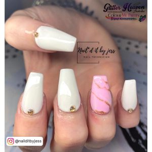 Elegant Pink And White Marble Acrylic Nails With Gold Rhinestones On Patterned Surface