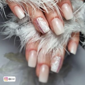 Elegant White Ombre Nails With Glitters Holding White Fur Over Marble Surfaces