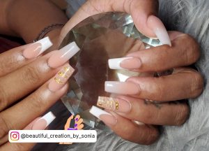 French Pink And White Ombre Coffin Nails With Gold Flakes Over Grey Fur