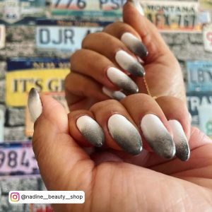 Gel Black And White Ombre Nails Over Brick Surface With Multiple Write-Ups