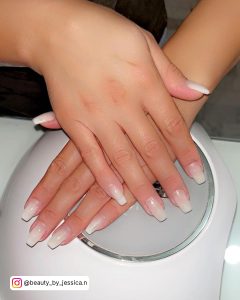 Gel Ombre White Tip Nails Laying On Uv Gel Dryer
