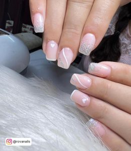 Glitter Clear And White Gel Nails With French Tips With Heart Design On White Fur