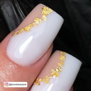 Glossy White Square Nails With Gold Foil Stripes And Nude Accent