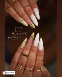 Gold And White Scales On Nude And White Stiletto Nails And Golden Rings