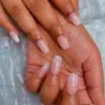 Gorgeous White Ombré Glitter Nails Over Marble Surface