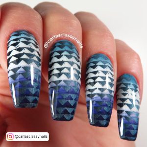 Gradient Stamping Blue And White Nail Art With Multiple Graded Blue Triangles Over A White Background