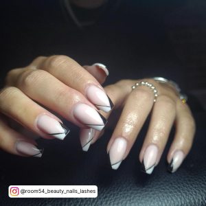 Half Black Half White French Tip Nails Over Black Leather Surface