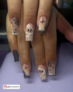 Halloween Matte Black And White Nails Art With Stars, Googly Eyes, Spider Webs, And Glitters