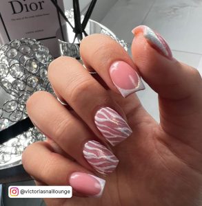 Hand With Pink And White Square Nails Infront Of Dior And Air Diffuser